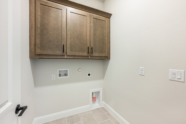 laundry area with cabinets, washer hookup, light tile patterned floors, gas dryer hookup, and hookup for an electric dryer