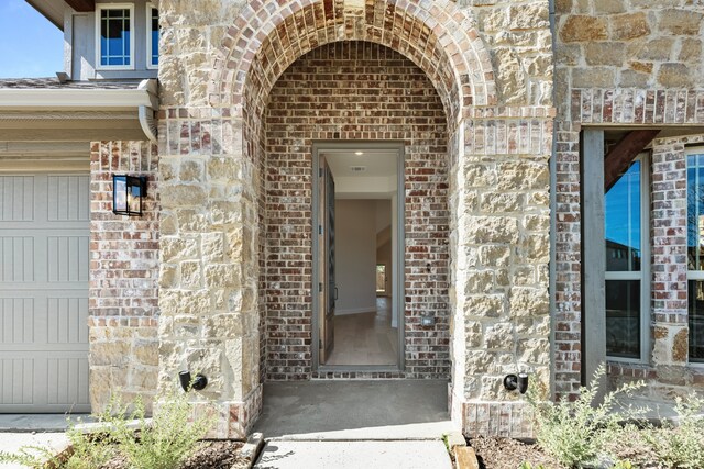 doorway to property with a garage