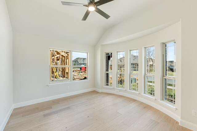 empty room featuring vaulted ceiling, light wood-type flooring, and ceiling fan