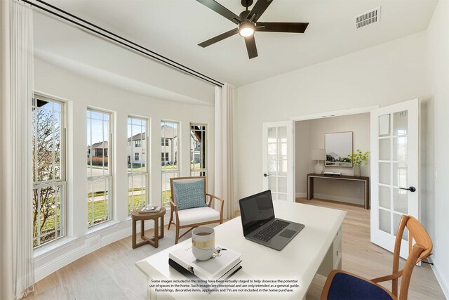 office with light hardwood / wood-style floors, french doors, and ceiling fan