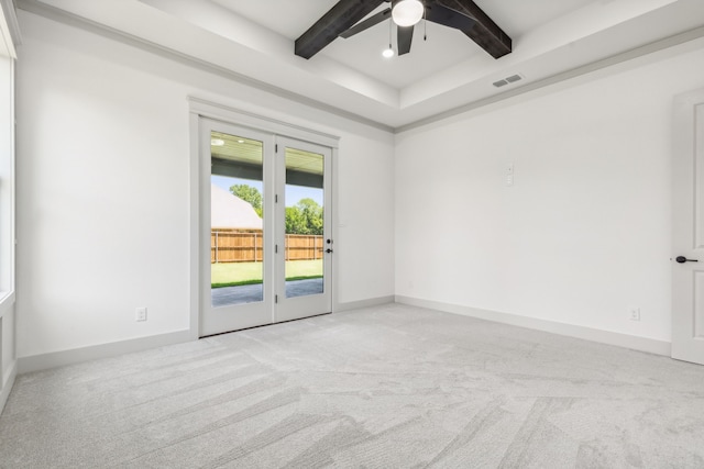 empty room with light carpet, beam ceiling, and ceiling fan