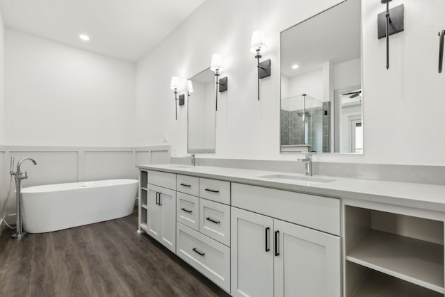 bathroom with vanity, hardwood / wood-style flooring, and shower with separate bathtub