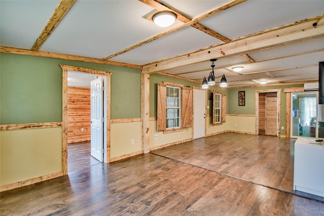 unfurnished living room with dark hardwood / wood-style flooring and beamed ceiling