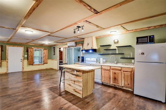 kitchen with an AC wall unit, white appliances, dark hardwood / wood-style floors, and a center island