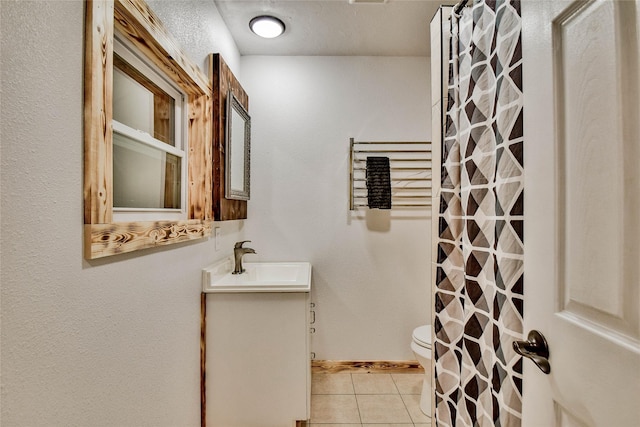 bathroom with toilet, vanity, tile patterned floors, and a shower with shower curtain