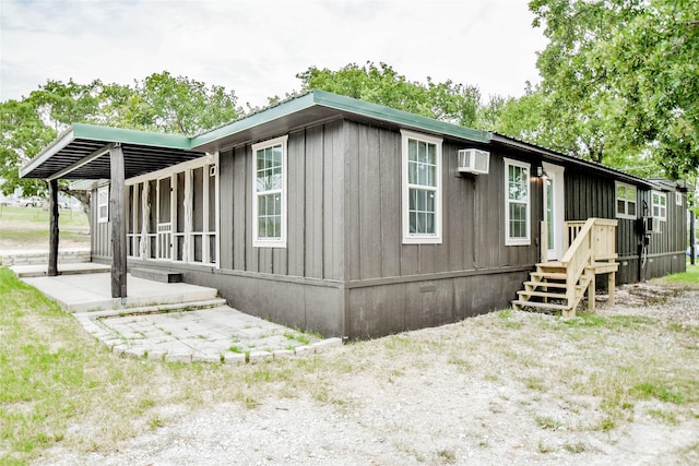 view of home's exterior with a wall mounted air conditioner