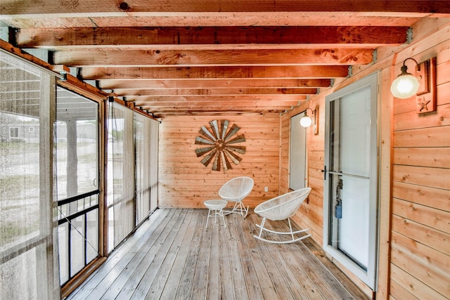 unfurnished sunroom with beamed ceiling