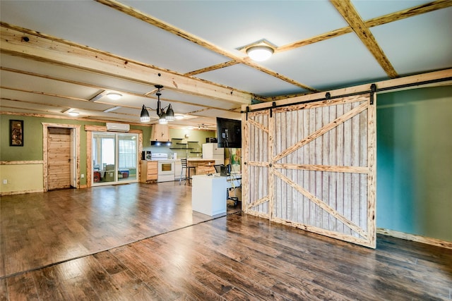 unfurnished living room featuring dark wood-type flooring and a barn door