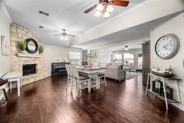 dining area featuring a textured ceiling, dark hardwood / wood-style flooring, and a wealth of natural light