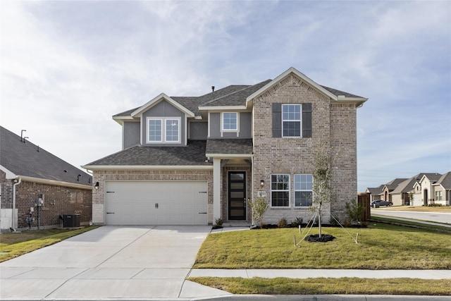 view of front of house featuring a front yard, a garage, and central air condition unit