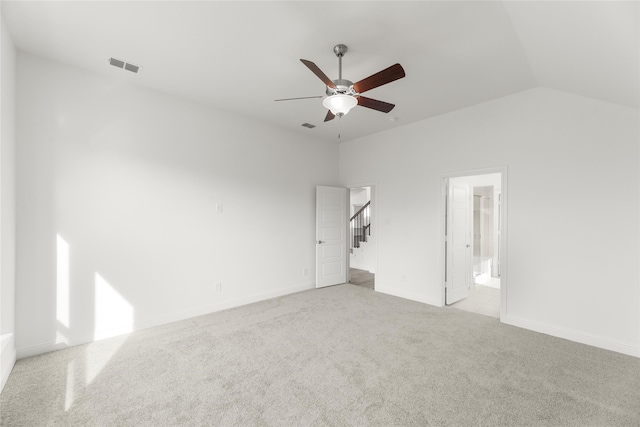 unfurnished bedroom with ensuite bathroom, ceiling fan, lofted ceiling, and light carpet