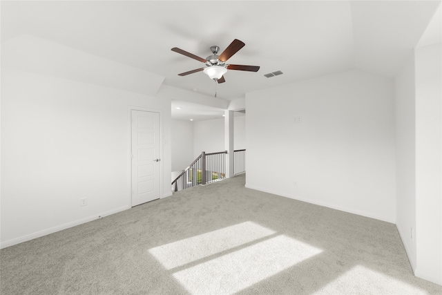 carpeted empty room featuring ceiling fan and lofted ceiling