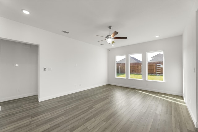 unfurnished room featuring ceiling fan and dark hardwood / wood-style floors