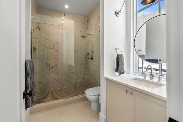 bathroom featuring tile patterned flooring, vanity, toilet, and walk in shower