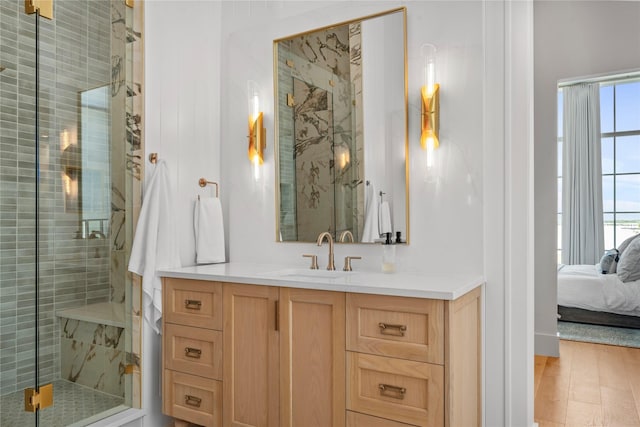 bathroom with vanity, wood-type flooring, and an enclosed shower