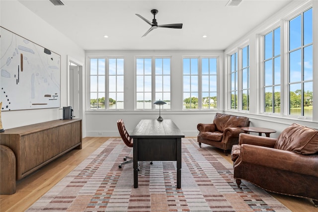 sunroom featuring ceiling fan and a healthy amount of sunlight