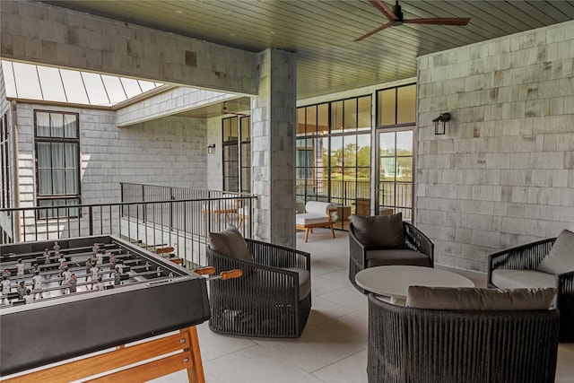 interior space featuring an outdoor living space and ceiling fan