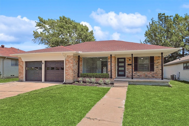 single story home featuring a garage, covered porch, central air condition unit, and a front lawn