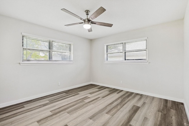 empty room featuring light wood-type flooring and ceiling fan