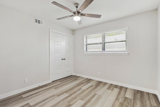 spare room featuring ceiling fan and light hardwood / wood-style floors