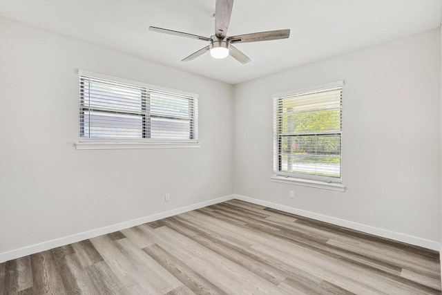 empty room with ceiling fan and light wood-type flooring