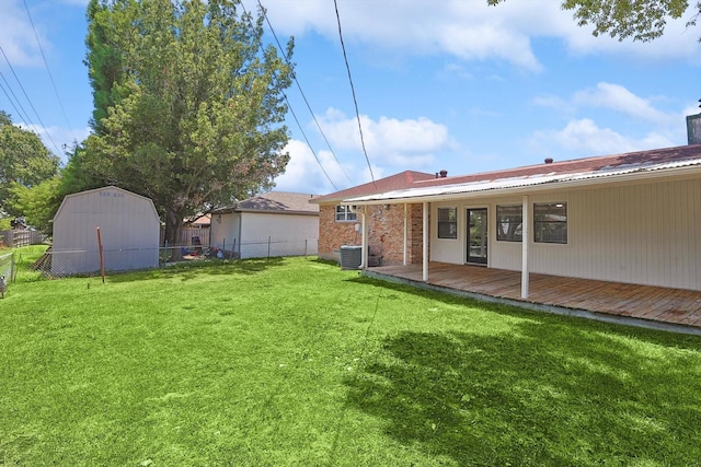 view of yard with central air condition unit and a deck