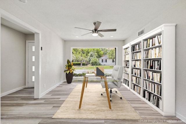 office space with light wood-type flooring and ceiling fan