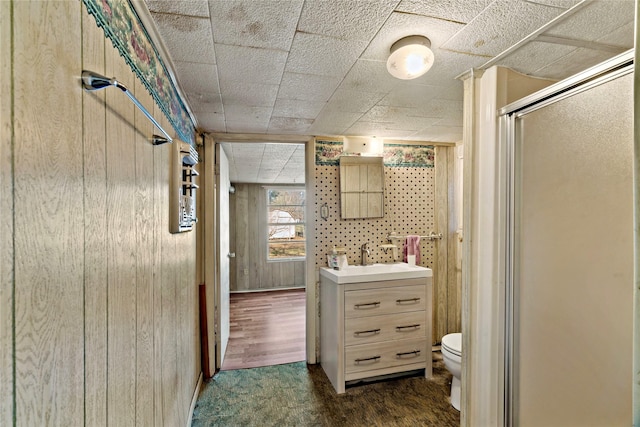 bathroom featuring vanity, hardwood / wood-style flooring, toilet, and an enclosed shower