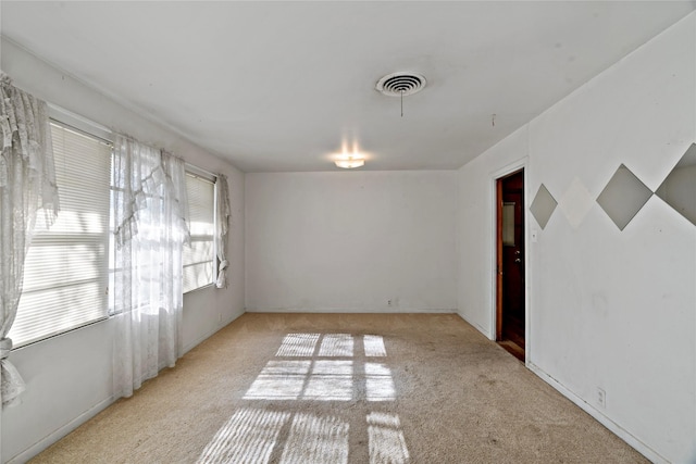 empty room featuring light carpet