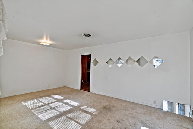 spare room featuring light colored carpet