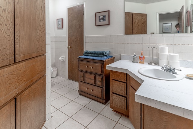 bathroom featuring backsplash, tile patterned floors, vanity, and tile walls