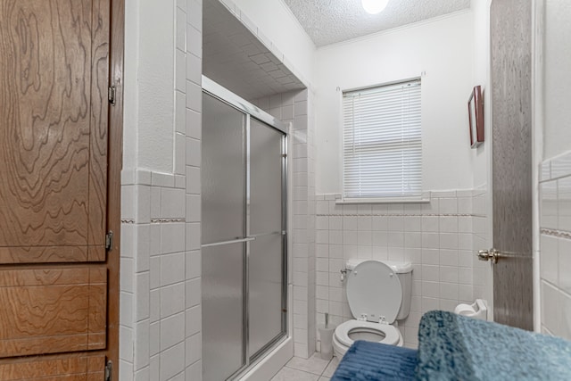 bathroom with an enclosed shower, tile walls, toilet, and tile patterned floors