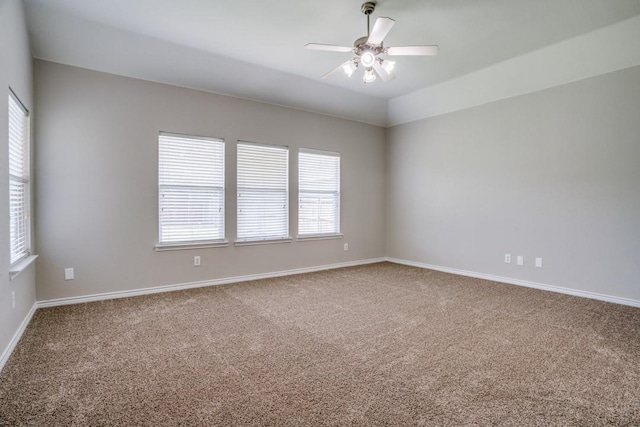 carpeted empty room featuring vaulted ceiling and ceiling fan