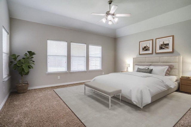 bedroom with multiple windows, ceiling fan, and carpet floors