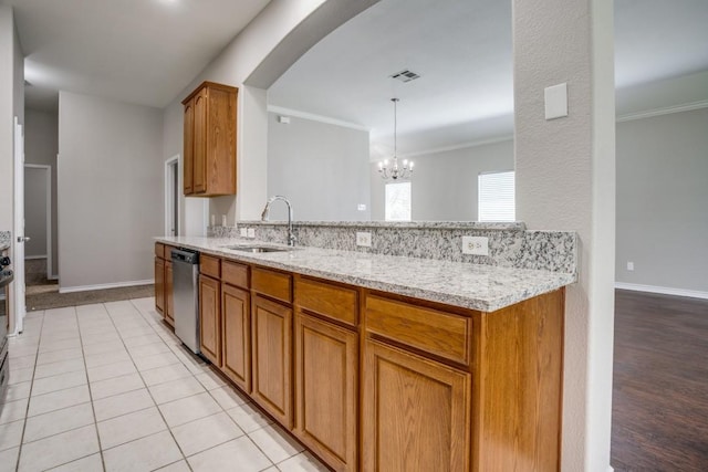 kitchen with light stone countertops, ornamental molding, sink, dishwasher, and a chandelier