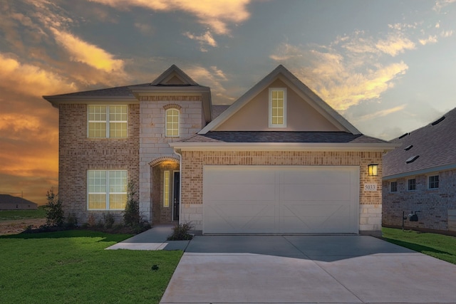 view of front of property featuring a yard and a garage