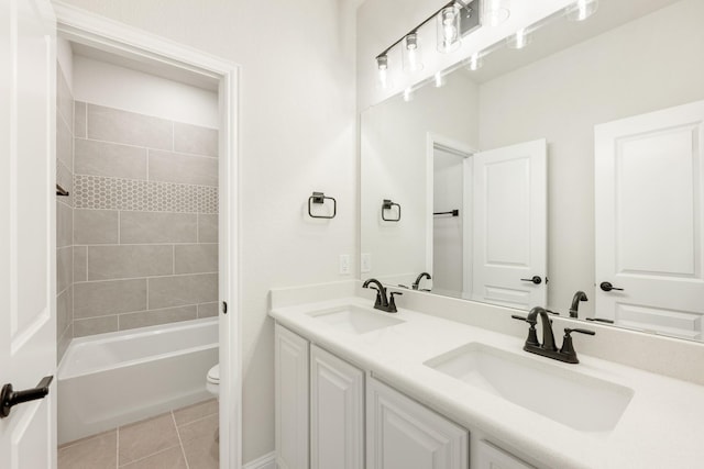 full bathroom with tile patterned flooring, vanity, toilet, and tiled shower / bath