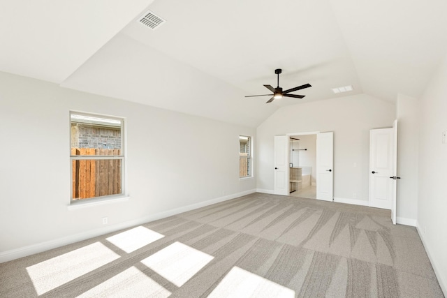 unfurnished bedroom featuring ensuite bathroom, ceiling fan, lofted ceiling, and light carpet