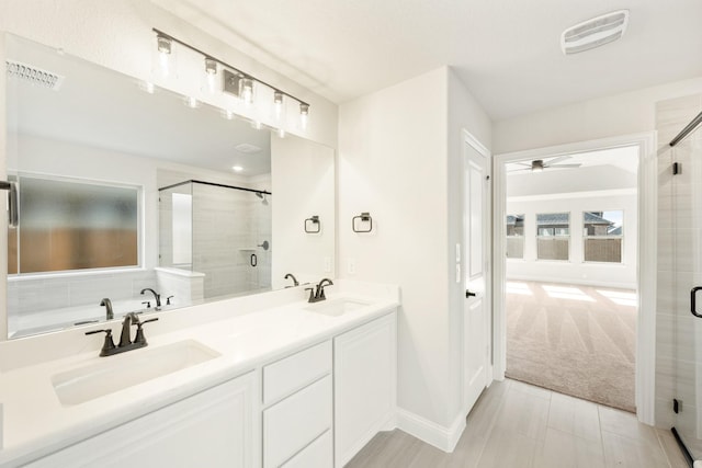 bathroom featuring separate shower and tub, ceiling fan, and vanity