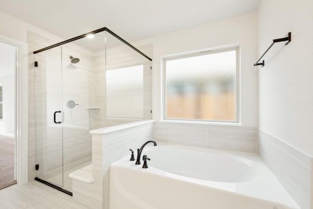 bathroom with shower with separate bathtub