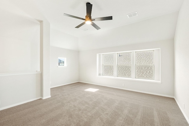 empty room with light colored carpet, ceiling fan, and lofted ceiling