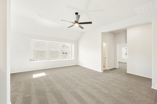 interior space featuring light colored carpet, ceiling fan, and lofted ceiling