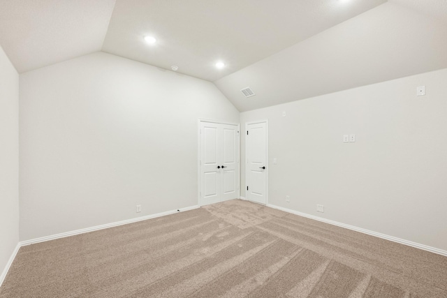 unfurnished room with lofted ceiling and carpet floors