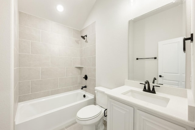 full bathroom featuring toilet, vanity, vaulted ceiling, and tiled shower / bath