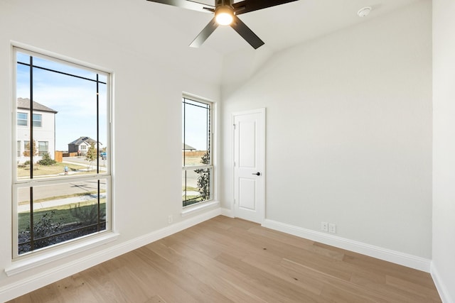 unfurnished room with ceiling fan, light wood-type flooring, a wealth of natural light, and lofted ceiling