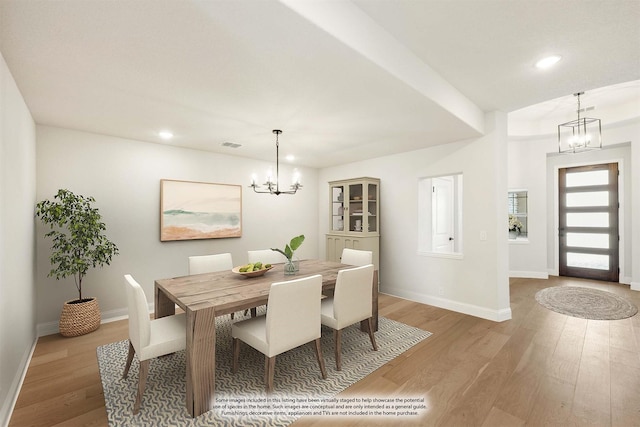 dining room featuring light hardwood / wood-style floors and a chandelier