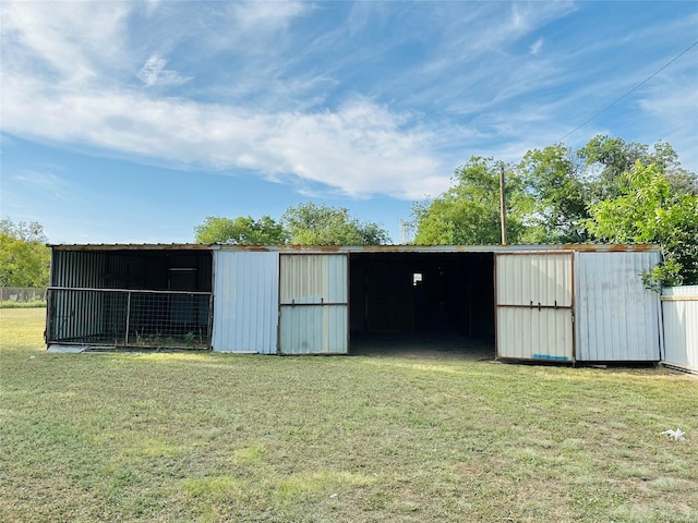 view of outdoor structure featuring a lawn