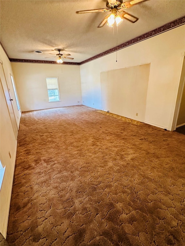 spare room featuring ceiling fan, ornamental molding, dark carpet, and a textured ceiling