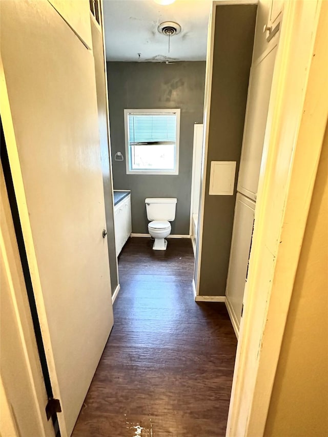 bathroom with wood-type flooring and toilet