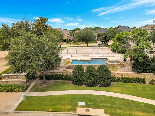 view of swimming pool featuring a lawn